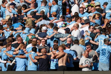Photo for Man City supporters cheer on their team during the Premier League match Manchester City vs West Ham United at Etihad Stadium, Manchester, United Kingdom, 19th May 2024 - Royalty Free Image