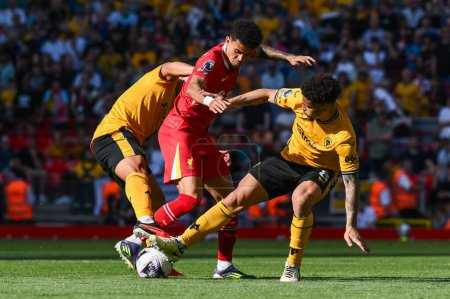Photo for Luis Daz of Liverpool is tackled by Joo Gomes of Wolverhampton Wanderers during the Premier League match Liverpool vs Wolverhampton Wanderers at Anfield, Liverpool, United Kingdom, 19th May 2024 - Royalty Free Image