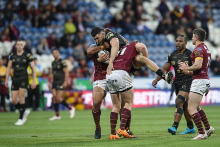 Photo for Dan Norman of Leigh Leopards is tackled by Jack Murchie of Huddersfield Giants during the Betfred Super League Round 12 match Huddersfield Giants vs Leigh Leopards at John Smith's Stadium, Huddersfield, United Kingdom, 24th May 2024 - Royalty Free Image