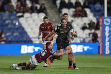 Photo for Matt Moylan of Leigh Leopards is tackled by Olly Russell of Huddersfield Giants during the Betfred Super League Round 12 match Huddersfield Giants vs Leigh Leopards at John Smith's Stadium, Huddersfield, United Kingdom, 24th May 2024 - Royalty Free Image