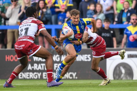 Photo for Cai Taylor-Wray of Warrington Wolves is tackled by Bevan French of Wigan Warriors during the Betfred Super League Round 13 match Warrington Wolves vs Wigan Warriors at Halliwell Jones Stadium, Warrington, United Kingdom, 1st June 2024 - Royalty Free Image