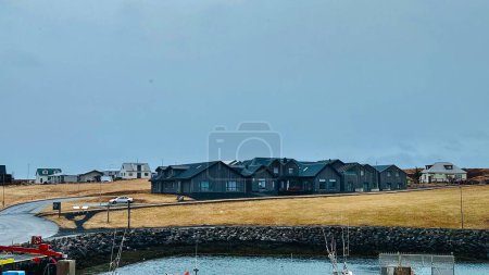 Islamic landscapes, stylish black building in Scandinavian style on the shore of the bay, high quality photo