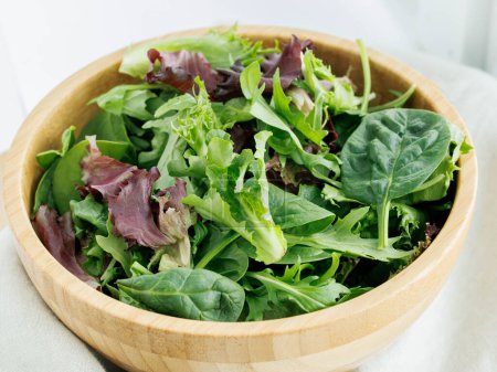 Photo for Fresh variety of salad greens in brown bowl view from above - Royalty Free Image