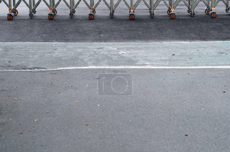 Photo for A metal wheel door entrance on asphalt floor beside a street. - Royalty Free Image