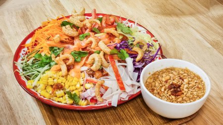 Photo for Serving of auspicious yusheng or yee sang with raw salmon sashimi in restaurant during Chinese New Year celebration in Malaysia - Royalty Free Image
