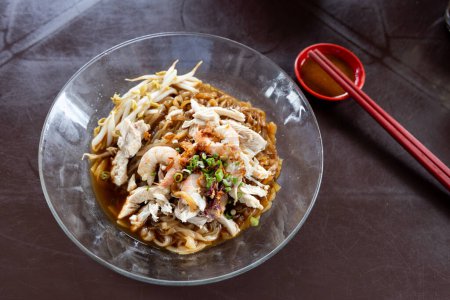 Photo for Ipoh popular dry shredded chicken and prawn hor fun noodle served with chili sauce dipping at hawker - Royalty Free Image
