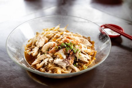 Photo for Ipoh popular dry shredded chicken and prawn hor fun noodle served with chili sauce dipping at hawker - Royalty Free Image