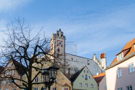Photo for Fuessen, Germany, is a famous Bavarian small town with a beautiful historic city centre. View along colourful historic buildings towards the castle. - Royalty Free Image