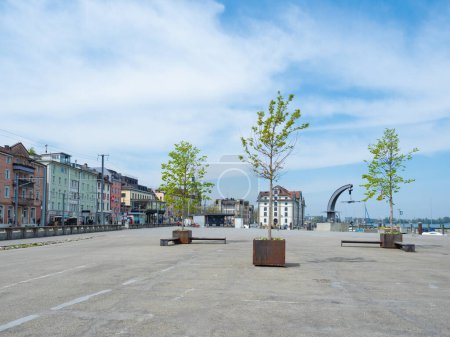 Photo for The city of Rorschach, Switzerland is directly situated at lake Constance. Situation of the big concrete plaza with single trees in front of the historic buildings of the old town. - Royalty Free Image