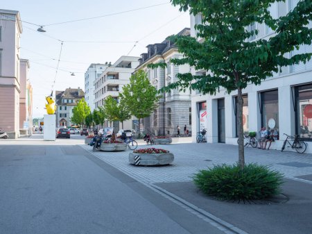 Photo for Redesigned street space in Romanshorn, Switzerland: Traffic-calmed areas with trees and flower pots in front of the train station - Royalty Free Image