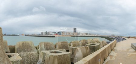 Photo for Oostende is a historic and famous destination for travellers at the North Sea coast. Sitatuation of the embankment of the harbour entrance with view towards the city centre. - Royalty Free Image