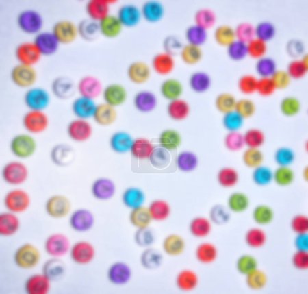 Not focus blur background photo of colorful round alphabet, colorful round numbers, round colorful letters on a white background