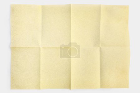 Close up parchment paper folded in eight, texture background