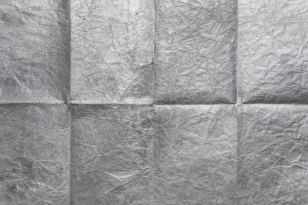 Photo for Silvery sheet of paper folded in eight, texture background - Royalty Free Image