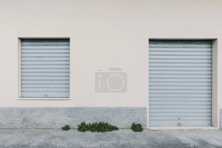 Photo for Lowered shutters of a shop closed, front view - Royalty Free Image