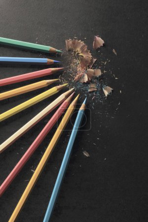 Photo for Sharpening colored pencils, black paper background - Royalty Free Image