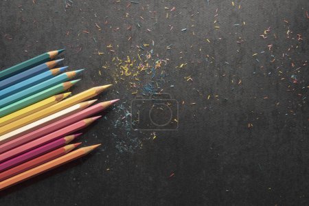 Photo for Sharpening colored pencils, black paper background - Royalty Free Image