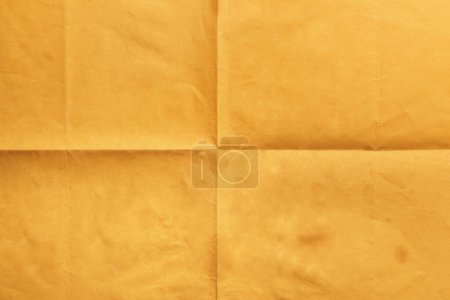 Photo for Close-up of old orange notepaper folded in four, texture background - Royalty Free Image