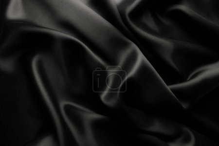 Foto de Elegante seda satinada negra con ondas, textura de fondo - Imagen libre de derechos