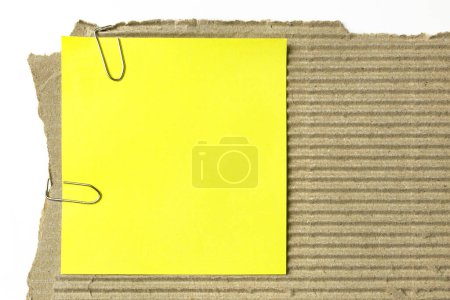 Photo for Yellow sticky note on piece of cardboard - Royalty Free Image