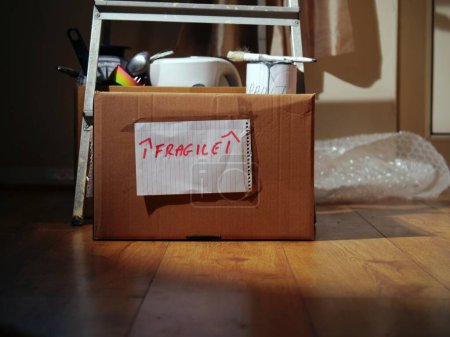 Photo for Moving home with fragile kitchen items in a box medium shot selective focus - Royalty Free Image