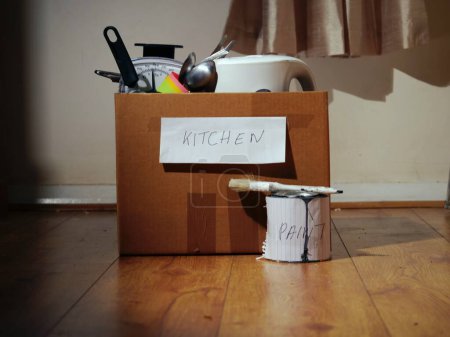 Photo for Moving home with fragile kitchen items in a box medium shot selective focus - Royalty Free Image