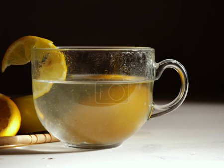 Making hot Lemon and honey for natural treatment of cold and flu close up shot selective focus