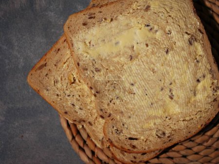 Slices of wholemeal bread with butter close up flat lay overhead close up shot selective focus
