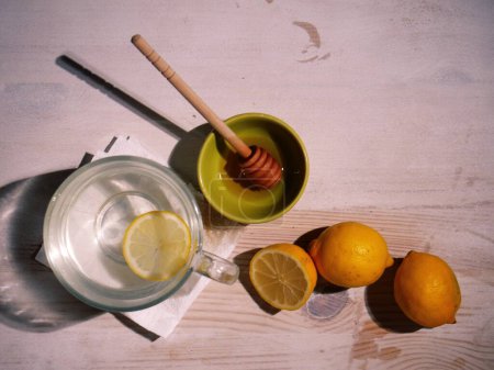Photo for Making hot Lemon and honey for natural treatment of cold and flu medium overhead flat lay shot selective focus - Royalty Free Image