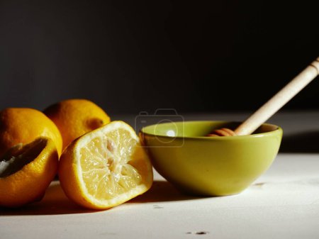 Photo for Making hot Lemon and honey for natural treatment of cold and flu medium shot selective focus - Royalty Free Image
