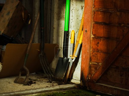 Photo for Garden tools in old wooden shed wide shot selective focus - Royalty Free Image