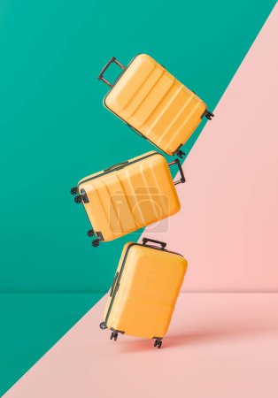 Three floating yellow suitcases against a split teal and pink background. Lightness and ease of travel. 3d rendering
