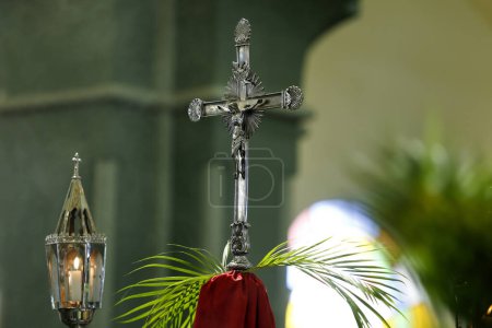 Photo for Holy Week. Cross decorated with green branches and lit lanterns. Traditional Catholic celebration Palm Sunday. Christian faith. Religious symbol. - Royalty Free Image