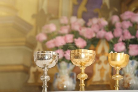 Foto de Chalice and ambula on the altar, moment of the holy mass - Consecration of bread and wine in the body and blood of Jesus - Sacred Host, liturgical objects - Imagen libre de derechos