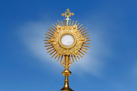 Monstrance for adoration in a Catholic church ceremony - Adoration of the Blessed Sacrament - religious symbol on blue background