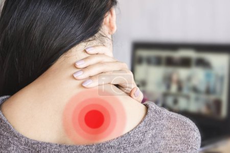 Photo for Woman Experiencing Shoulder Blade Pain from Prolonged Computer Use, Overworked at the Desk - Royalty Free Image