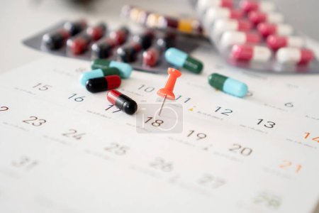 Photo for Overuse and long-term of Antibiotics concept with a pack of medicines and pin mark on a calendar - Royalty Free Image