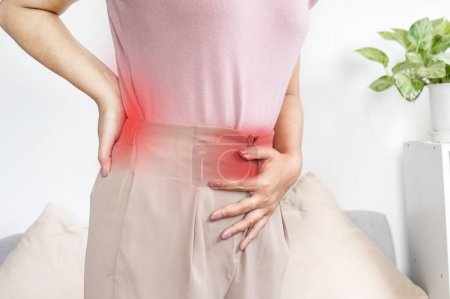 Foto de Mujer que sufre de dolor de espalda y dolor de estómago durante el período menstrual - Imagen libre de derechos