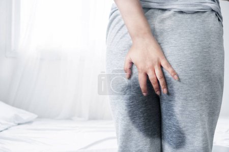 Photo for Old woman peeing in her pant after waking up in the morning, Stress Urinary incontinence concept - Royalty Free Image