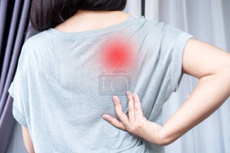 Photo for Woman suffering from Scapulocostal Syndrome Back and Shoulder Muscle Pain - Royalty Free Image