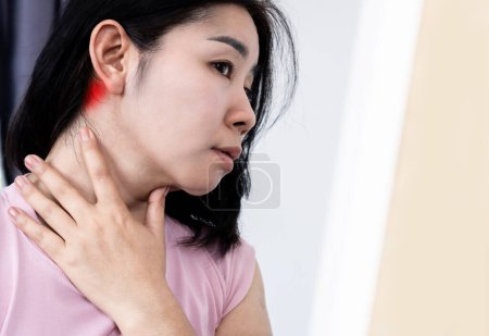 Photo for Asian woman suffering from lymphadenitis, lymph node inflammation and feeling pain , swollen behide the ear - Royalty Free Image