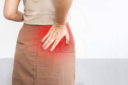 Photo for Woman suffering from Piriformis Syndrome , feeling pain and numbness in butt, hip or upper leg - Royalty Free Image