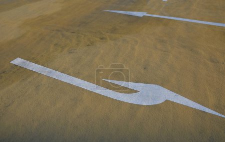 Photo for Yellow painted road surface with traffic arrows. asphalt coloring in a beige tone. it makes a different impression than the gray and black color of the asphalt - Royalty Free Image