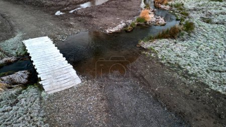 Photo for Garden park, land with winding stream and ponds. a ford with a road and a wooden bridge across the river. formerly this stream flowed in a straight, straightened watercourse. people restored winding - Royalty Free Image