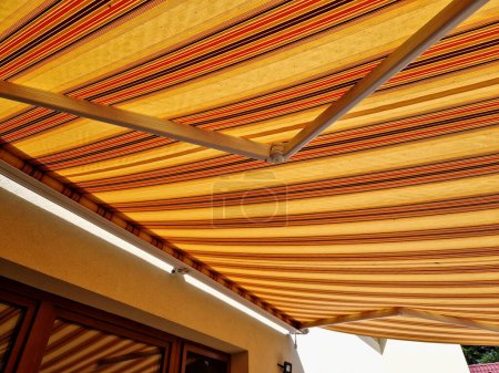 Photo for Awnings underline the architectural appearance of your house. Above all, they are able to shade larger areas of terraces, balconies or glass windows. Furthermore, they complete the architectural appearance of the object and become its integral part - Royalty Free Image