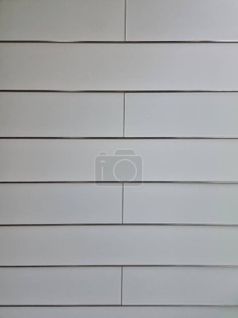Photo for Wall covering with glass stripes on the wall. joints are stainless steel or aluminum expansion sheet. vertical division of the walls of the chancellery entrance hall, matte - Royalty Free Image