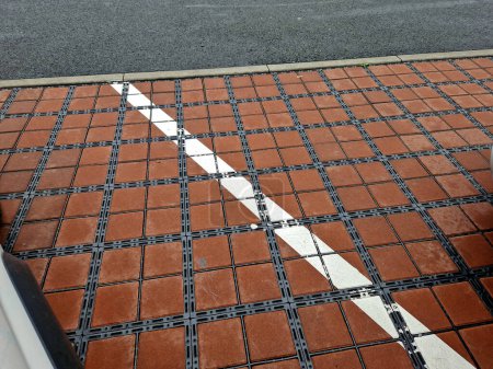 Photo for Drainage paving with infiltration holes between concrete blocks in the parking lot of the department store, lines, white, road marking - Royalty Free Image