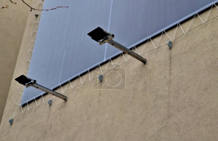 Photo for Advertising tarpaulin installed by cable into the metal galvanized eye on the facade of the house. Mobile advertising solutions, easily replaceable content for outdoor use on apartment buildings - Royalty Free Image