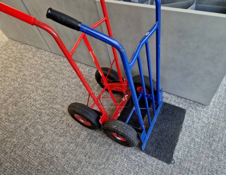 moving handcarts ready to transport plants. The two-wheeled wheelbarrow is ideal for transporting furniture and appliances indoors. red and blue on the carpet