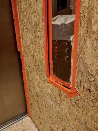 Photo for Office equipment via a personal elevator must be sealed and covered with boards to protect the stainless steel interior of the luxury elevator. construction work and reconstruction - Royalty Free Image